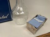 a glass vase and a small box on a table