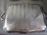 a silver tray sitting on a table next to a pair of shoes