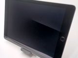 a tablet computer sitting on top of a white table