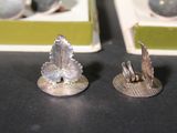 two pieces of silver that are on a table