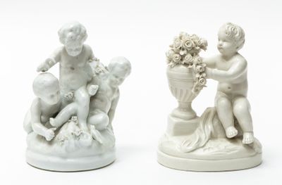 two figurines of a boy and a girl sitting on a rock