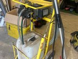 a yellow cart with a gas can and a hose