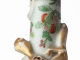 a vase that has a bird on the top of it