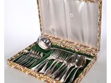 a box with silverware in it on a white surface
