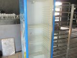 an empty refrigerator in the middle of a room