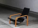 a black chair that is sitting in a parking garage