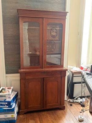 un vaisselier en bois dans un coin de la pièce