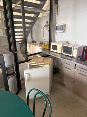 a kitchen with a refrigerator, microwave, and a refrigerator freezer