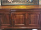 a picture of a painting on the wall above a wooden cabinet