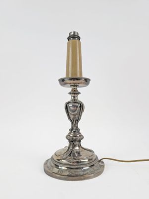 an antique silver plated table lamp on a white background