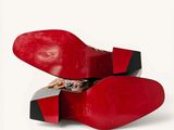 a pair of red shoes that are sitting on top of each other