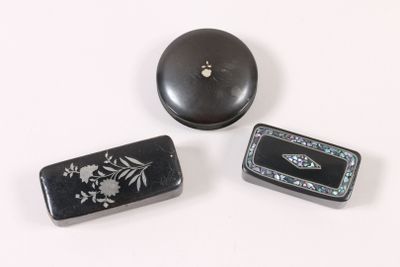 three black and white boxes sitting on top of a white surface