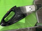 a black and green iron sitting on top of a green table