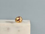 the gold ring is sitting on top of a white marble block