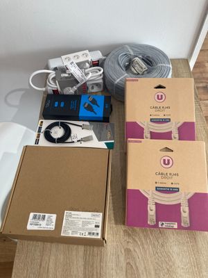 a box of electronics sitting on a table next to a box of wires