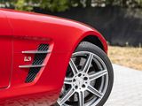 the red sports car is parked on the side of the road