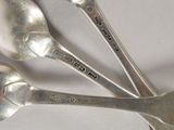 three spoons that are sitting on a table