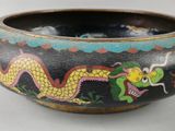 a black bowl with a dragon painted on it