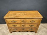 a wooden chest of drawers with ornate carvings on the drawers