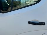 a close up of a car door handle with a reflection of a building in the window