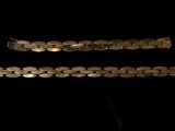 two pieces of silver bracelets on a black background