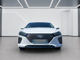 the front view of a white car in a white room