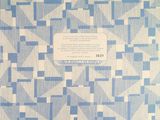 the back cover of a blue and white quilt with a pattern of squares