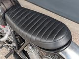 a close up of a motorcycle with a black seat