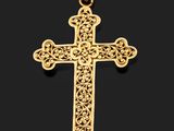 un pendentif en forme de croix en or sur fond noir