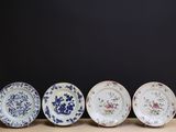 four plates are lined up in a row on a table