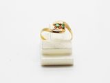 a close up of a gold ring with a green stone on it