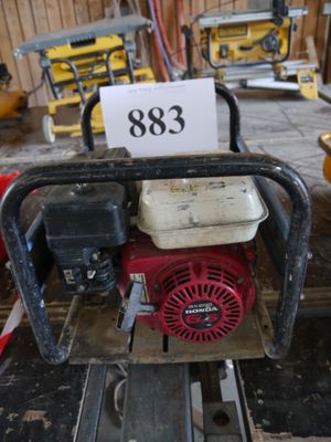 a picture of a small engine on a pallet in a workshop