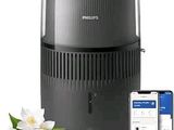 Le purificateur d'air Philips se trouve à côté d'un iPhone et d'une fleur