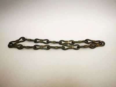 a close up of a metal chain on a white surface