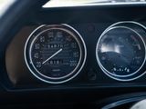 a close up of a car dashboard with a speedometer and gauges