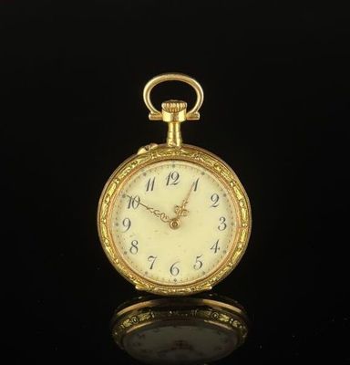 an antique gold pocket watch with roman numerals on the face