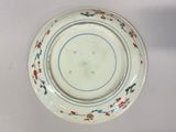a white plate with blue and red designs on it