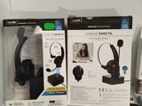 three boxes of headphones on a desk with a remote