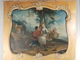 une photo d'un tableau posé sur un chevalet, représentant une femme et un enfant