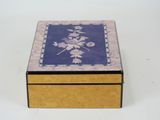 a wooden box with a floral design on it