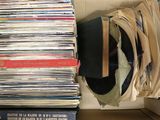 a box full of records and a hat on top of it