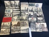 several old postcards of old buildings and buildings on a table