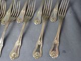 six forks and six spoons sitting on a table