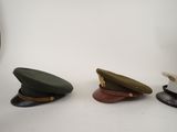 several hats are lined up on a white surface