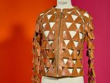 leather jacket on a mannequin stand against a red and orange wall