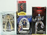three boxes of action figures on a white surface