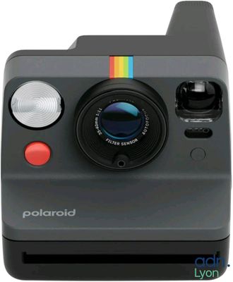 an image of a polaroid camera sitting on top of a white surface