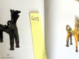 a book with a picture of a horse and a horse figurine on it