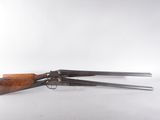 a pair of antique shotguns on a white background