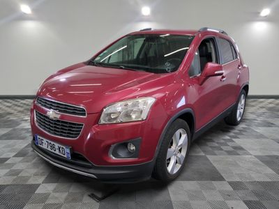the red chevrolet trax is parked on a checkered floor